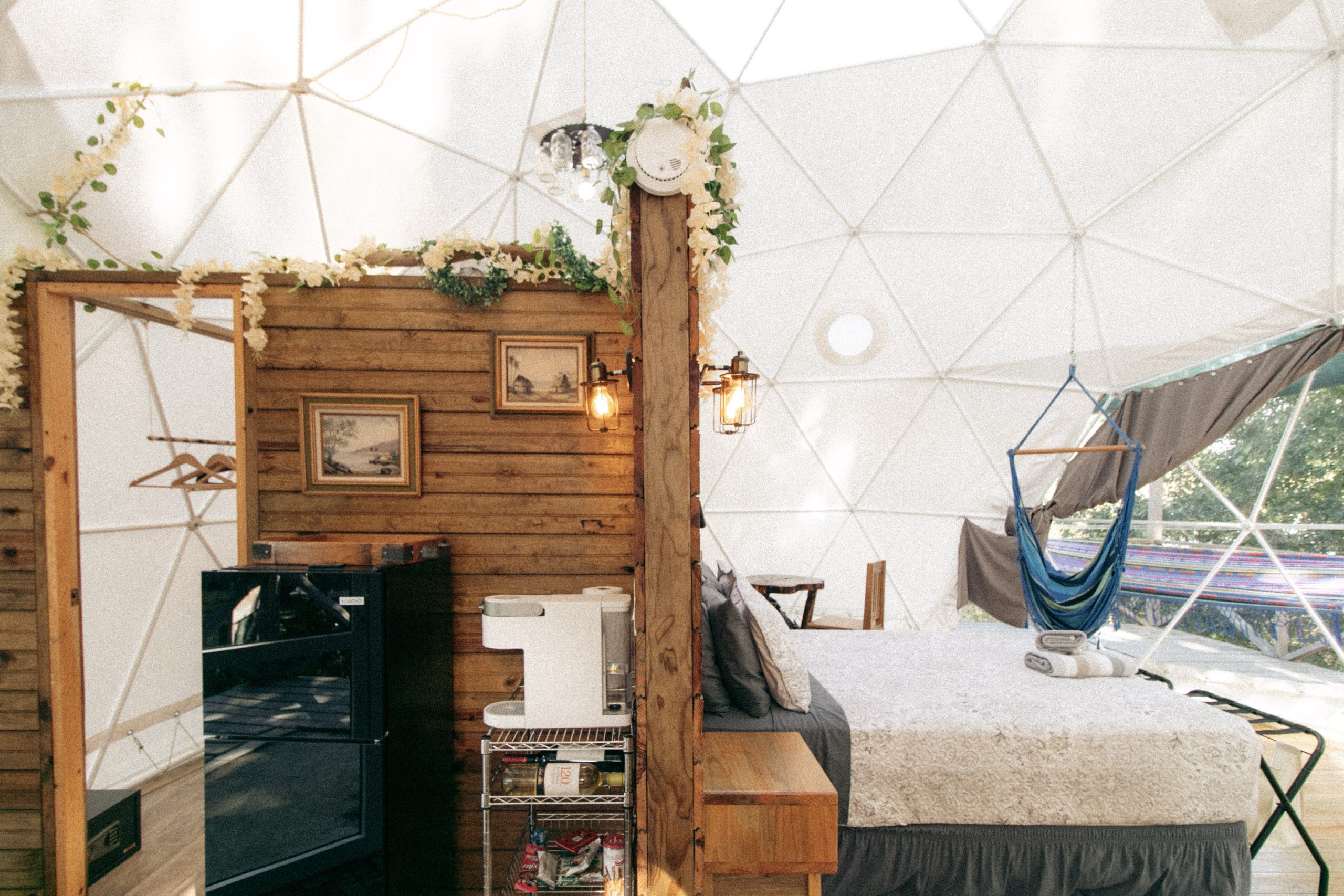 Fridge and coffee maker and bed shown in listing